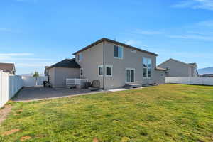 Back of house featuring a fenced backyard, stucco siding, and a patio