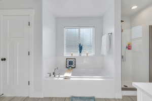 Full bath featuring a shower stall and a garden tub