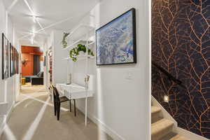 Hall featuring carpet and stairs