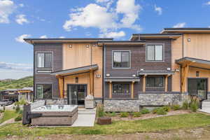 View of front of house with stone siding