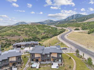 Aerial view of property and surrounding area with mountains