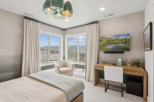 Bedroom with a desk and carpet