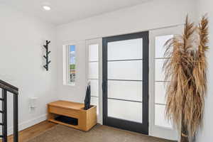 Entrance foyer with wood finished floors and recessed lighting