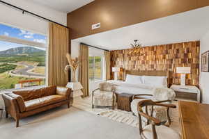 Bedroom with a chandelier, a mountain view, and carpet floors