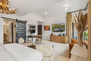 Carpeted bedroom featuring a barn door, lofted ceiling, a chandelier, and recessed lighting