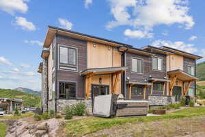 View of front facade with stone siding and a mountain view