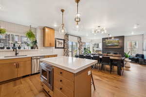 Kitchen with light countertops, appliances with stainless steel finishes, tasteful backsplash, a kitchen island, and recessed lighting