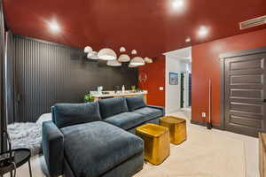 Carpeted living area featuring recessed lighting and an accent wall