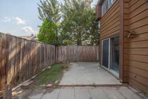 Fenced backyard with a patio