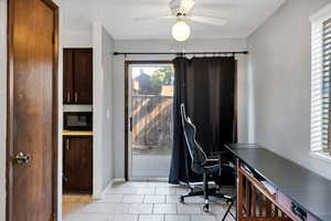 Home office with plenty of natural light, light tile patterned floors, a ceiling fan, and a textured ceiling