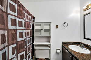 Bathroom featuring vanity and toilet