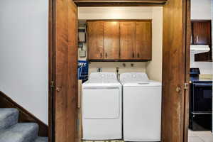 Laundry room featuring cabinet space and washer and dryer