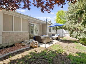 View of yard with outdoor lounge area and a patio area