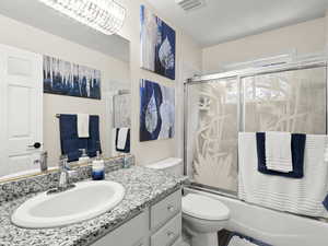 Full bathroom with vanity and shower / bath combination with glass door