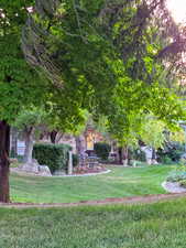 View of the patio from a distance. HOA maintained landscaping with a park-like setting