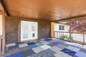 Unfurnished sunroom with french doors