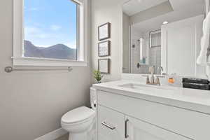 Full bath with vanity, a tile shower, and recessed lighting