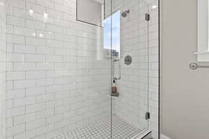 Full bath featuring a shower stall