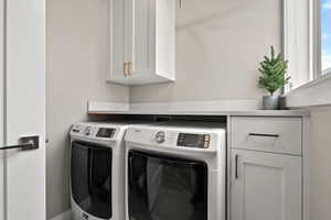 Laundry area with cabinet space and washer and dryer