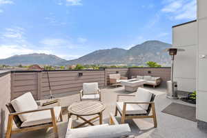 View of patio / terrace featuring a mountain view and an outdoor living space with a fire pit