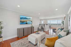 Living area featuring crown molding, recessed lighting, and hardwood / wood-style floors
