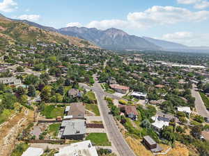 Aerial view of property's location with a mountainous background and nearby suburban area