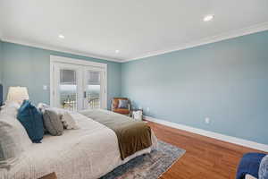 Bedroom featuring access to outside, french doors, wood finished floors, ornamental molding, and recessed lighting