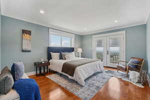 Bedroom featuring access to exterior, french doors, ornamental molding, wood finished floors, and recessed lighting