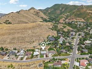 Aerial view of property and surrounding area featuring nearby suburban area