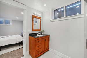 Ensuite bathroom with vanity and recessed lighting
