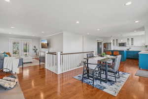 Dining space with ornamental molding, recessed lighting, light wood-style floors, and french doors