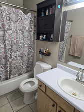 Bathroom featuring vanity, tile patterned flooring, and shower / bathtub combination with curtain