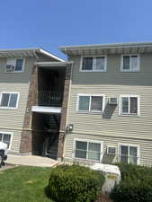 View of front of property featuring stairs, a patio area, and a front yard