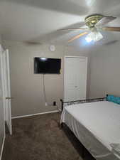 Bedroom with carpet floors, a ceiling fan, and a closet
