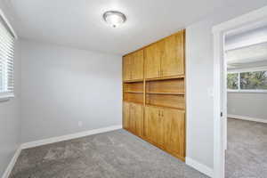 Unfurnished bedroom with carpet flooring, a closet, and a textured ceiling