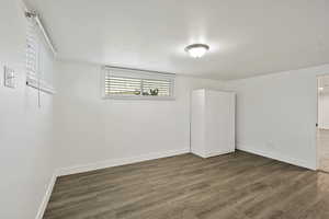 Unfurnished bedroom featuring wood finished floors and a closet