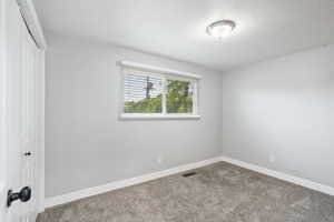 Unfurnished bedroom with a closet and carpet floors