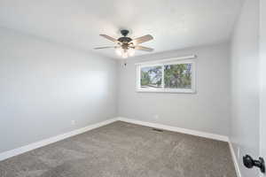 Unfurnished room featuring carpet and a ceiling fan