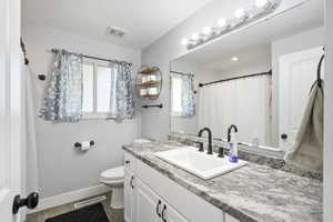 Full bath featuring vanity and wood finished floors