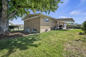 Rear view of house featuring brick siding and a patio