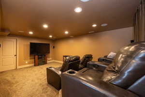 Cinema room featuring light colored carpet and recessed lighting