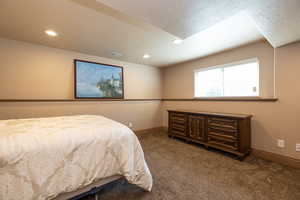 Bedroom with carpet, recessed lighting, and a textured ceiling