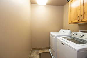 Laundry area with cabinet space and washer and dryer