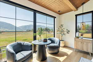 Sunroom with a mountain view and healthy amount of natural light