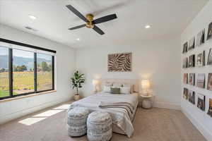 Carpeted bedroom with recessed lighting and a ceiling fan