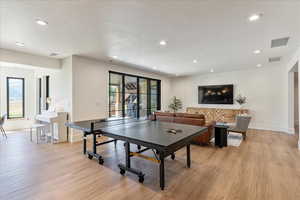 Playroom featuring light wood-style flooring and recessed lighting