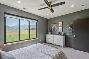 Carpeted bedroom featuring recessed lighting, a mountain view, and ceiling fan