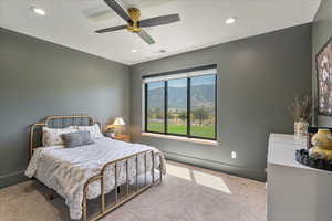 Carpeted bedroom featuring recessed lighting, a mountain view, and ceiling fan