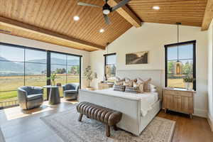 Bedroom featuring a mountain view, wood finished floors, recessed lighting, a wooden ceiling with exposed beams, and ceiling fan