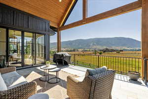View of patio / terrace featuring a mountain view, a rural view, and a grill